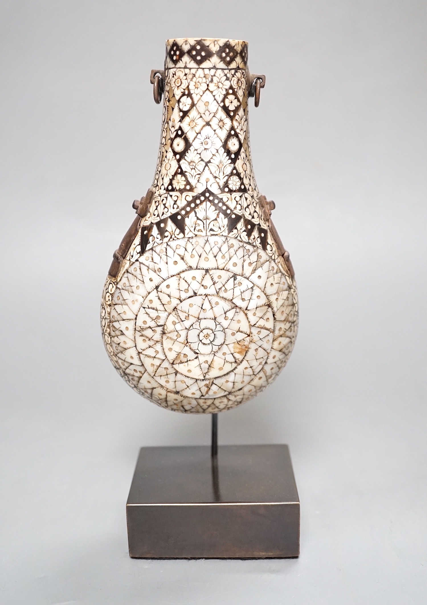 A powder flask, Etawah, India, 19th century, Mother-of-pearl, ivory, horn and black lac on wood - 17cm